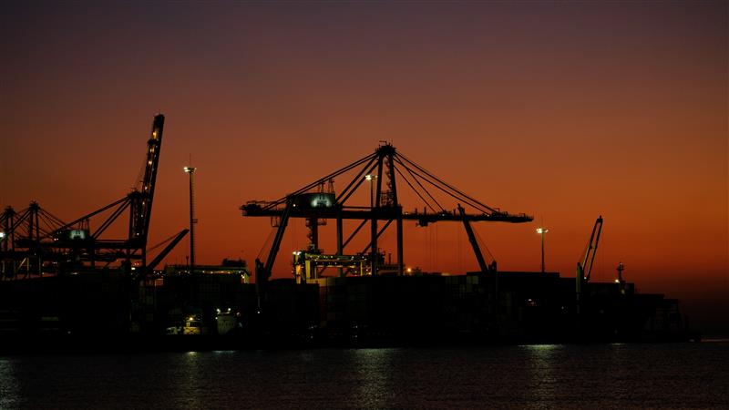Quay cranes and terminal infrastructure at dusk